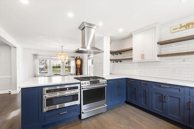 320 Putnam Ave, Port Chester, NY 10573 - kitchen with open shelves, stainless steel appliances, blue cabinetry, range hood, and a peninsula