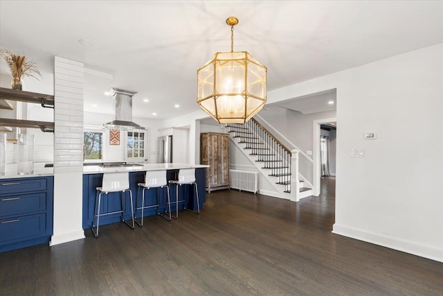 320 Putnam Ave, Port Chester, NY 10573 - kitchen featuring blue cabinets, dark wood-style flooring, a chandelier, range hood, and light countertops