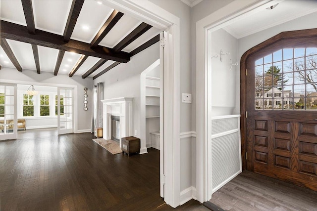 320 Putnam Ave, Port Chester, NY 10573 - entrance foyer with dark wood-type flooring, a high end fireplace, beamed ceiling, and baseboards