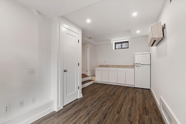 320 Putnam Ave, Port Chester, NY 10573 - bar area with freestanding refrigerator, a wall mounted AC, dark wood-style flooring, recessed lighting, and baseboards