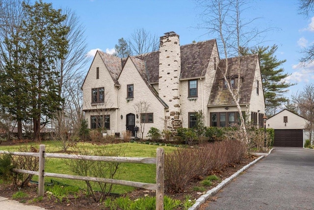 320 Putnam Ave, Port Chester, NY 10573 - view of front of home featuring a chimney, an outbuilding, a garage, and a front lawn