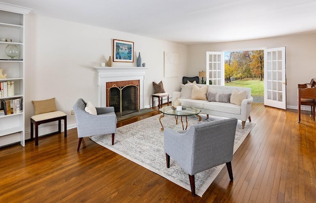 living room featuring wood-type flooring and a fireplace