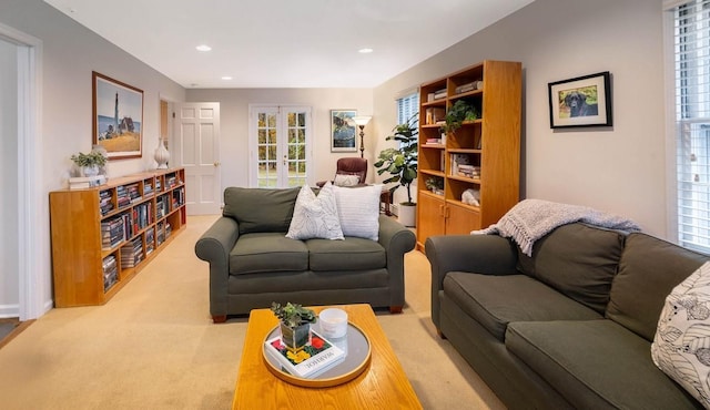 living room featuring light colored carpet and french doors