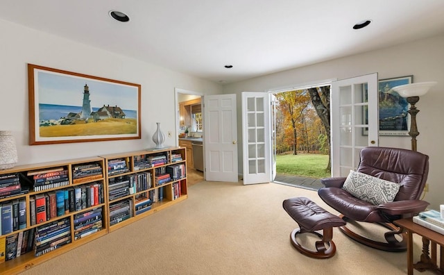 sitting room with carpet and french doors