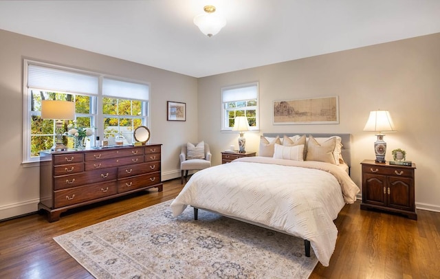 bedroom with dark hardwood / wood-style floors