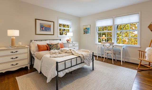 bedroom with multiple windows, a baseboard radiator, and dark hardwood / wood-style floors