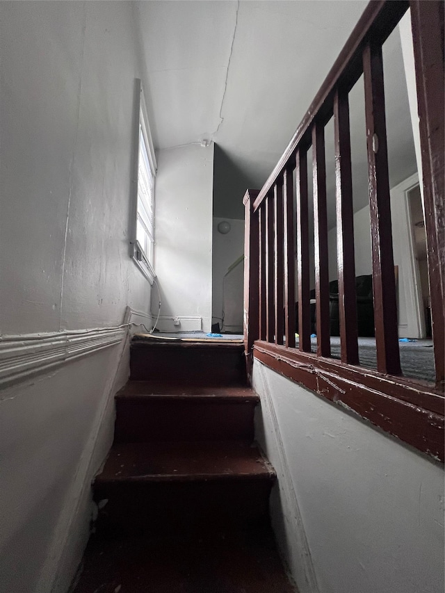 staircase with lofted ceiling