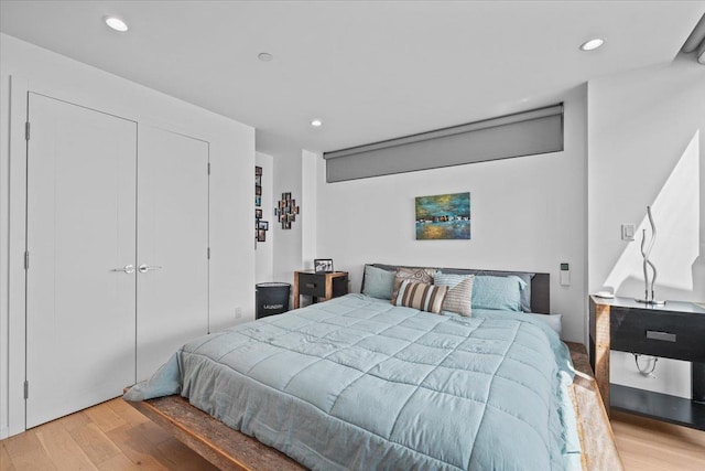 bedroom with hardwood / wood-style flooring and a closet