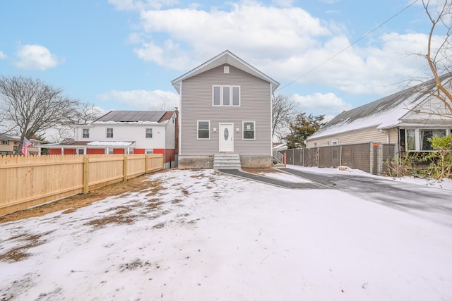 view of snow covered back of property