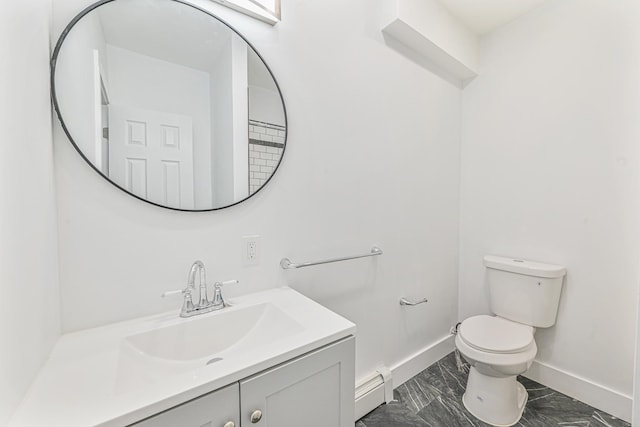 bathroom with vanity, toilet, and a baseboard heating unit