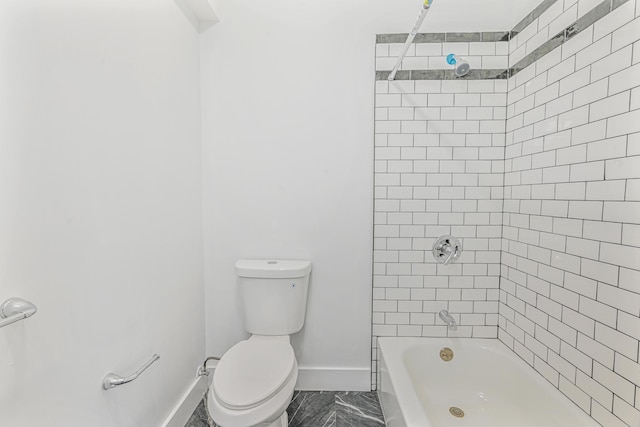 bathroom featuring toilet and tiled shower / bath combo