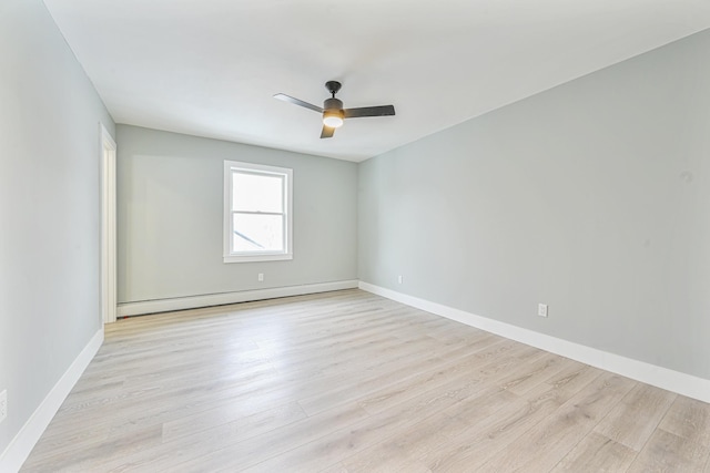 spare room featuring a baseboard radiator, ceiling fan, and light wood-type flooring