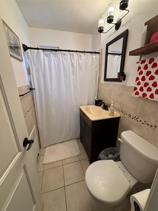 bathroom with tile patterned floors, toilet, tile walls, vanity, and a shower with shower curtain