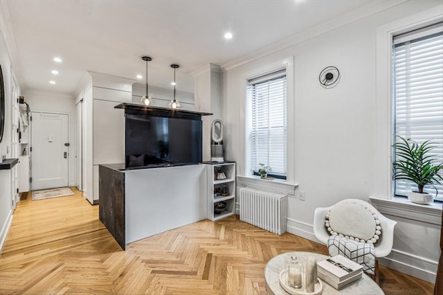 living room with crown molding, white cabinetry, hanging light fixtures, radiator heating unit, and light parquet floors