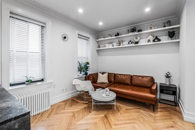 living room featuring ornamental molding, radiator heating unit, a wealth of natural light, and light parquet floors