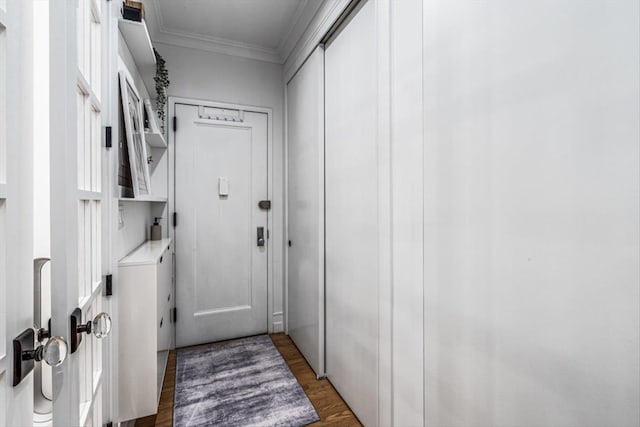 entryway featuring dark hardwood / wood-style flooring and crown molding