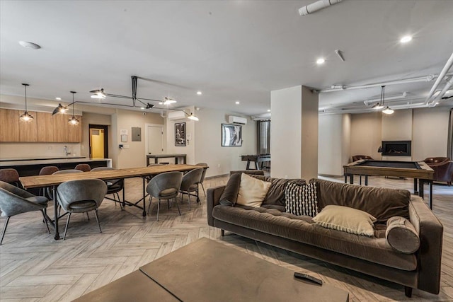 living room with light parquet flooring and a wall mounted AC