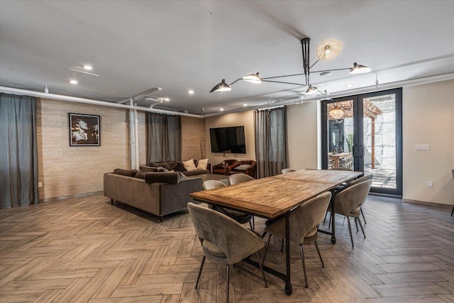 dining space with french doors and parquet flooring