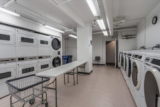 clothes washing area with stacked washer and dryer and washing machine and dryer