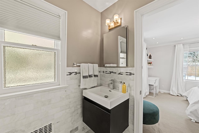 bathroom with tile walls and vanity