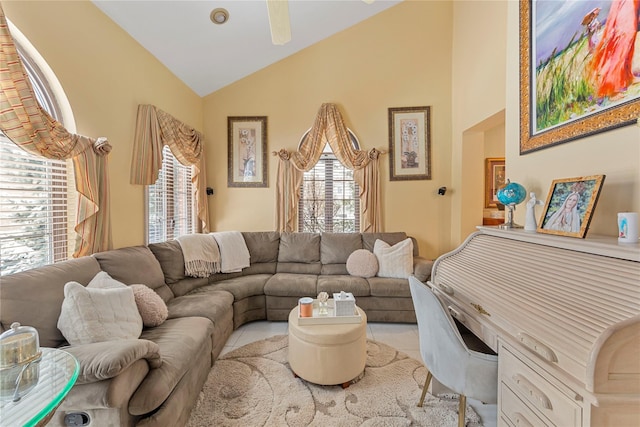 living room with lofted ceiling, ceiling fan, and light tile patterned flooring