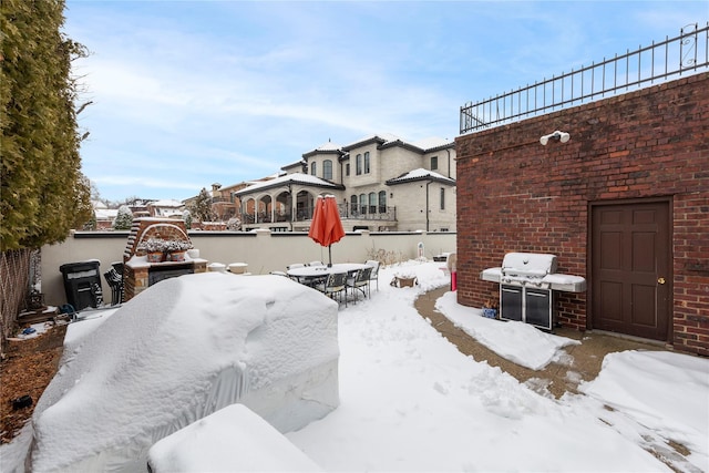 snow covered patio with grilling area