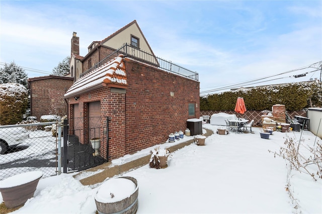 snow covered property featuring a garage