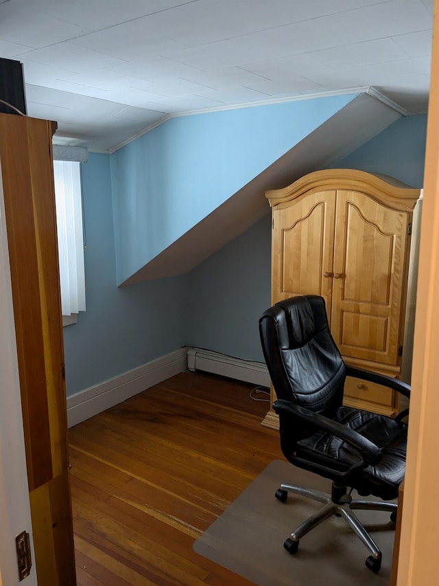 office with a baseboard radiator, baseboards, vaulted ceiling, and wood finished floors