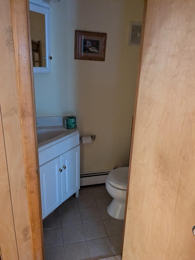 half bath featuring visible vents, toilet, vanity, baseboard heating, and tile patterned flooring