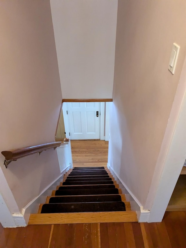 staircase with wood finished floors