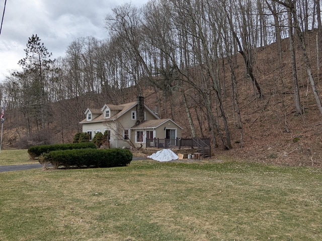 view of front of property with a front yard and a deck