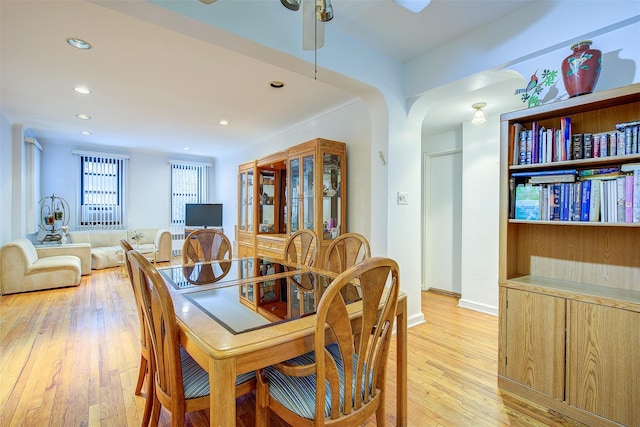 dining space with ceiling fan and light hardwood / wood-style flooring