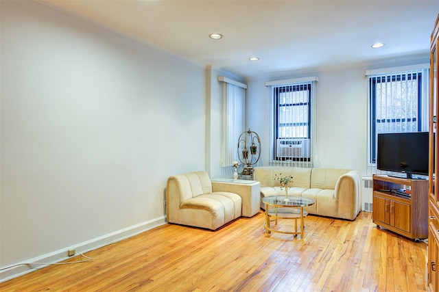 living room featuring radiator heating unit and light wood-type flooring