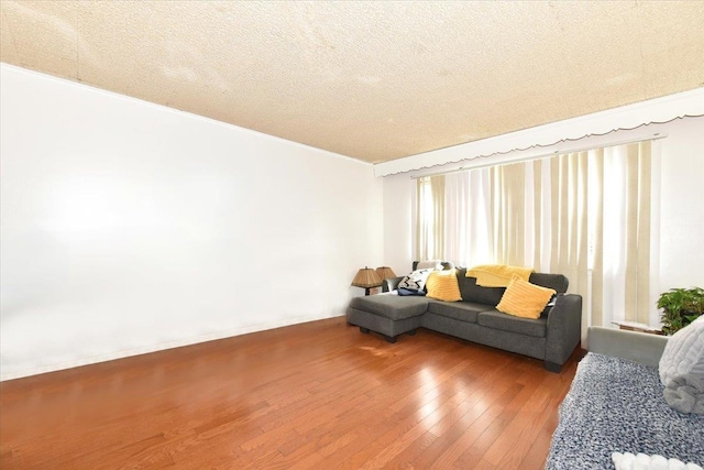 176-17 127th Ave, Jamaica, NY 11434 - living area with a textured ceiling, baseboards, and hardwood / wood-style floors