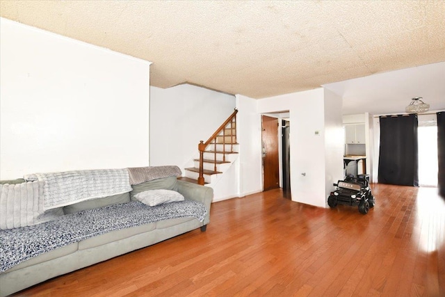 176-17 127th Ave, Jamaica, NY 11434 - living area with a textured ceiling, hardwood / wood-style floors, and stairway