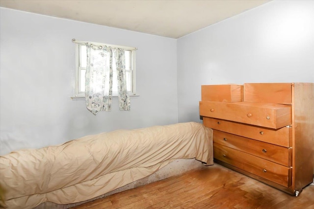 176-17 127th Ave, Jamaica, NY 11434 - unfurnished bedroom featuring wood finished floors