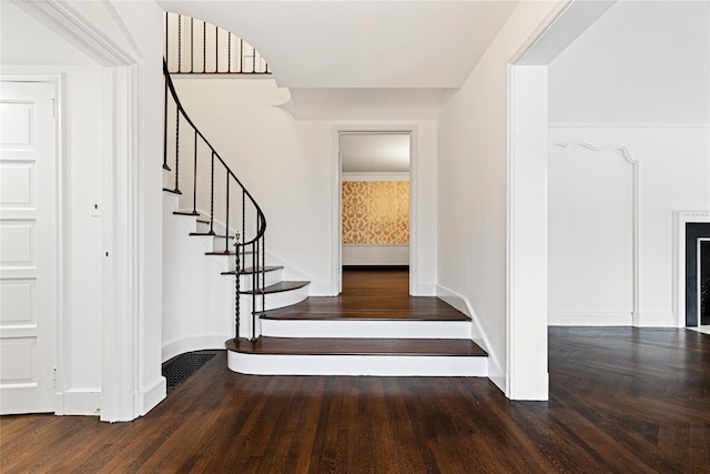 stairs with baseboards and wood finished floors