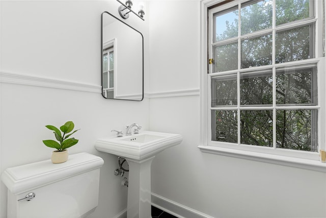 bathroom with toilet and a sink