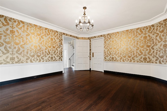 unfurnished room featuring a wainscoted wall, hardwood / wood-style floors, and wallpapered walls