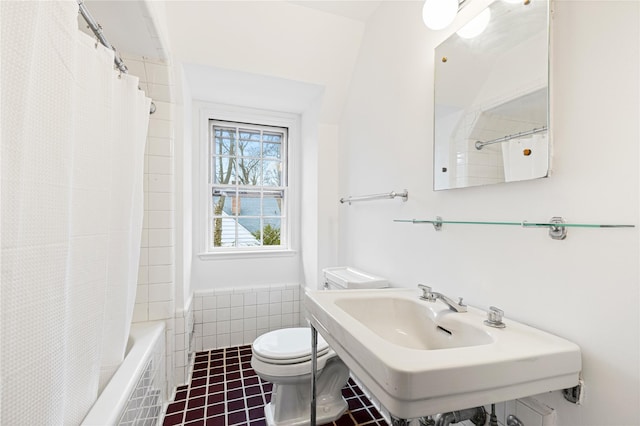 bathroom with toilet, tile patterned flooring, and a sink