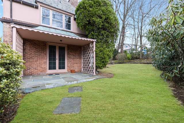 view of yard featuring french doors and a patio area