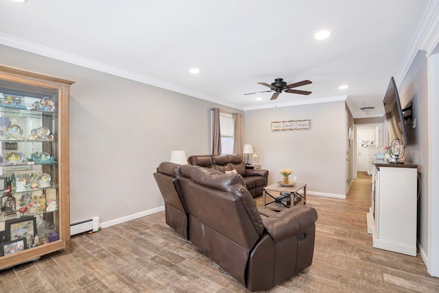 living room featuring hardwood / wood-style flooring, a baseboard radiator, ornamental molding, and ceiling fan