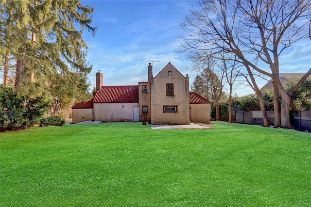 back of property with a lawn