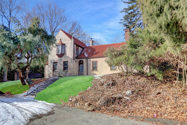 mediterranean / spanish home featuring a front lawn