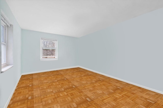 spare room with baseboards