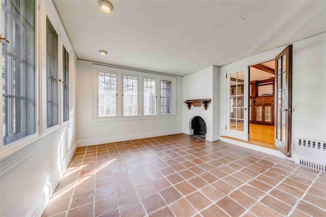 unfurnished living room with radiator heating unit