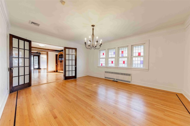 unfurnished dining area featuring french doors, ornamental molding, radiator heating unit, and hardwood / wood-style floors