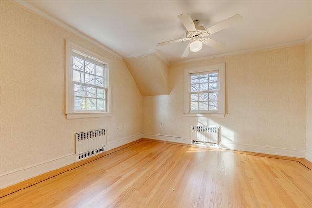 bonus room featuring hardwood / wood-style flooring, radiator, and ceiling fan