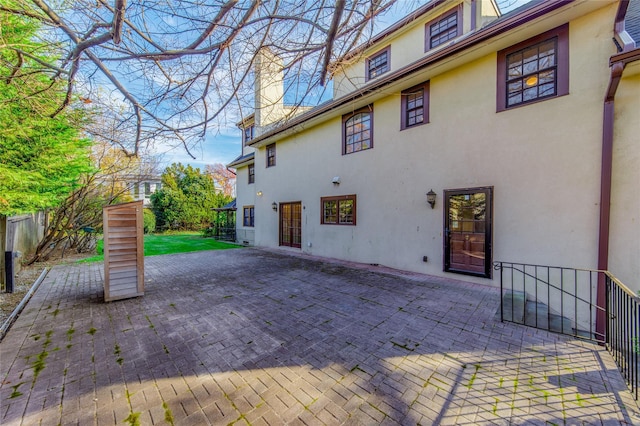 rear view of property featuring a patio area