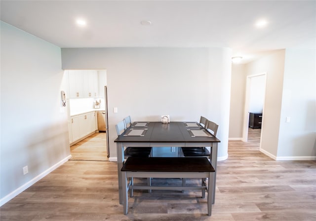 dining area with light hardwood / wood-style flooring